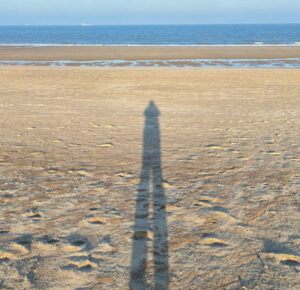 shadow figure standing on the beach