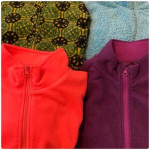 4 colorful fleece jackets, folded